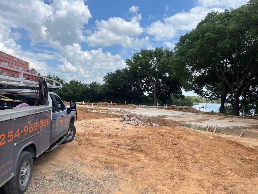 TX Plumbing Service & Repair truck and trailer at a residential jobsite in Stephenville, TX